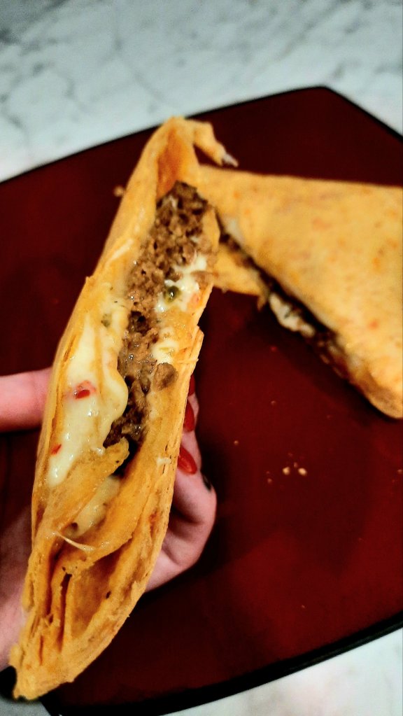 Prozis vegan chili wraps with protein and fiber, boca burger, sliced jalapeño jack cheese, salsa ranch dressing.. high protein healthy vegetarian fitness food. Kae Audhild tattooed hand model. Nails done using una gella almond tips and beetles autumn orange glitter gel polish. Autumn 2023 manicure. 