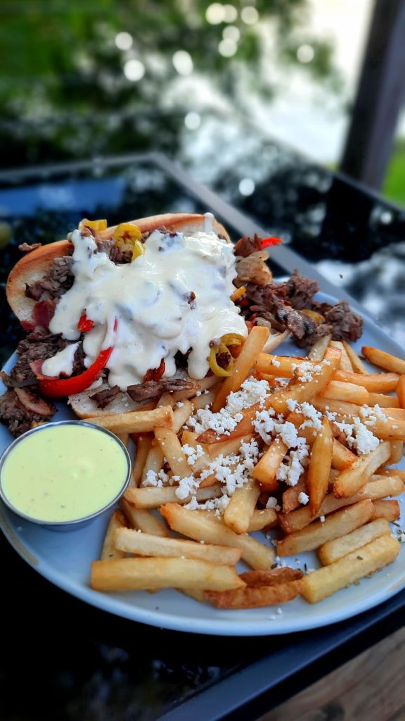 MJ's Cheesesteak with French fries topped with crumbled feta cheese at MJ's Bar and restaurant in Owego ny