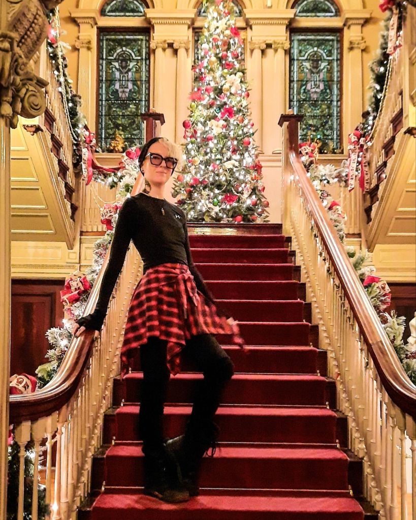 Kae Audhild visiting the Roberson Museum in Binghamton, NY for the 2024 Christmas tree display - haunted staircase in Roberson mansion