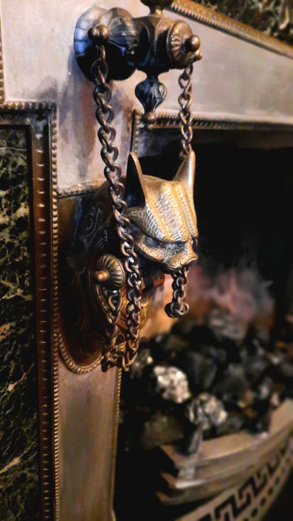 The fireplace in the Phelps mansion library has some interesting features - griffins and marble