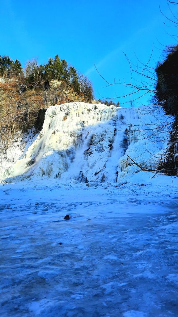 An icy Ithaca Falls in late February 2025 - photo by Kae Audhild travel hiking adventure blogger