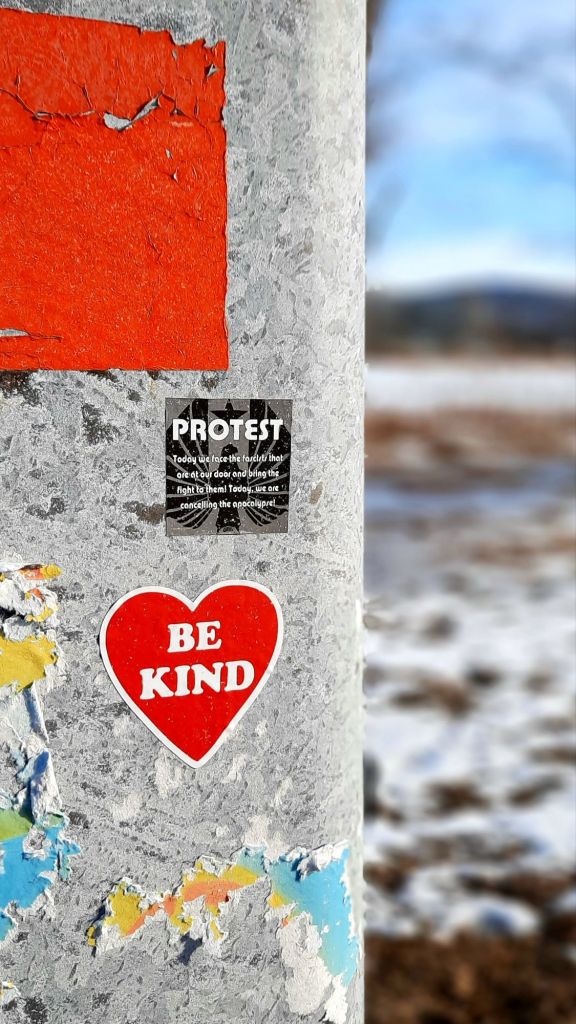 Be kind. ❤️ stickers on a post in Ithaca, NY