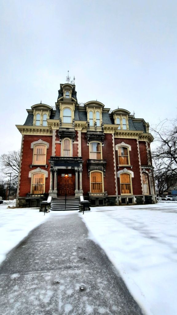 The Phelps Mansion Museum in Binghamton, NY. The 'false' third floor was a later addition to the building, which is not currently in use, other than for storage. The front gate is chained off and visitors are to enter through the side.