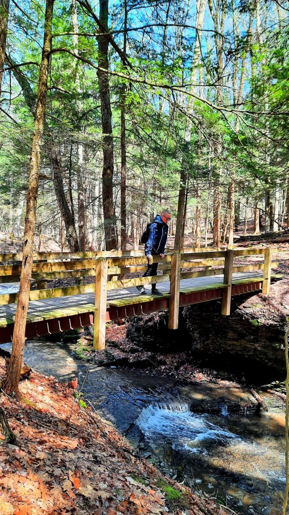 The gorge trail is currently closed, but the rim trails are open to explore. - Kae Audhild hiking at Fillmore Glen State Park in Moravia, NY - New York travel blogger