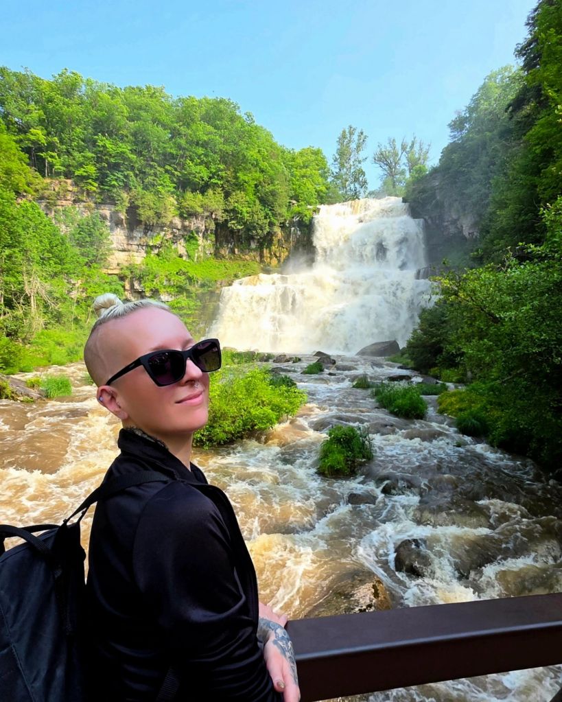 Kae Audhild standing on the bridge in front of Chittenango Falls.