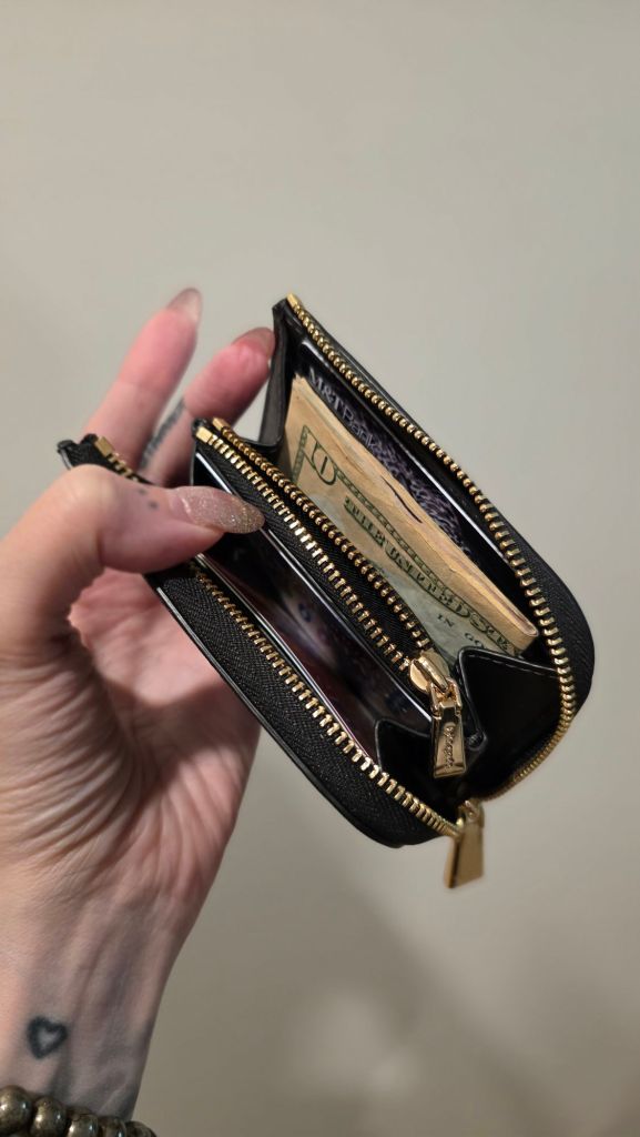 The inside of the Kate Spade Devin zip card case has 4 card slots and a built in coin purse.