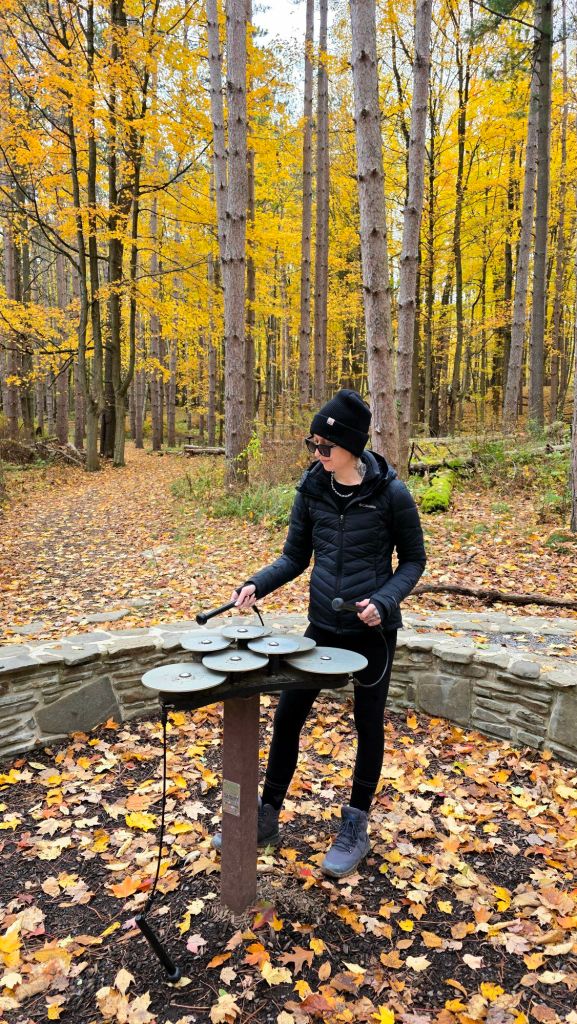 Kae Audhild playing music art the ANT Autism Nature Trail at Letchworth State Park