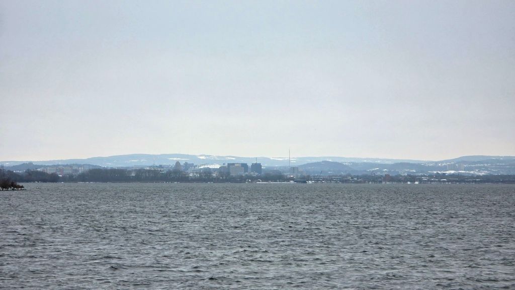 Snowy winter photo of Onondaga Lake with Syracuse NY in the background, December 2025 hiking the east shore trail