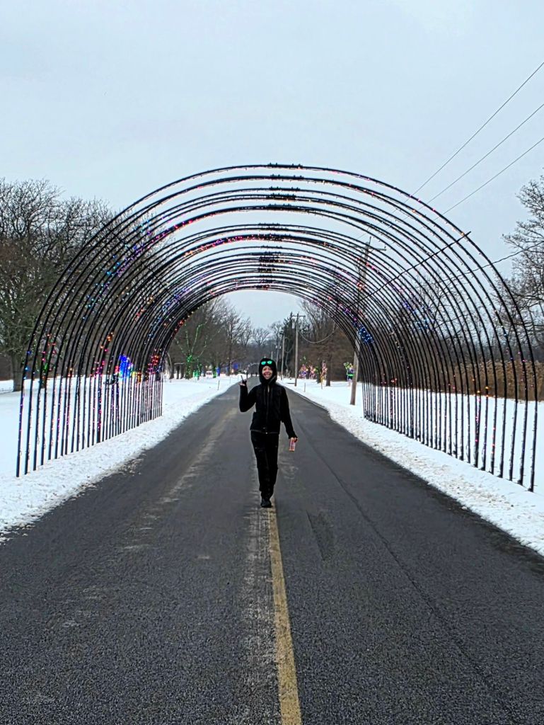 Kae Audhild walking through the rainbow tunnel at lights on the Lake in Liverpool, NY - December 6, 2025