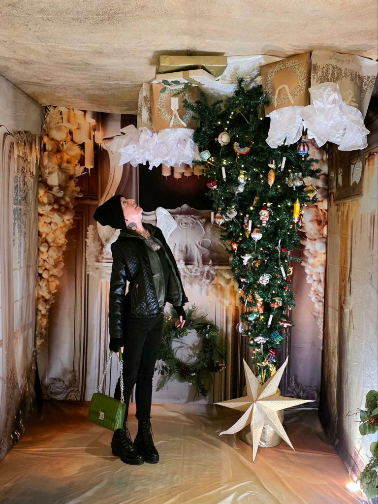Kae Audhild with upside down Christmas tree display at Home for the Holidays at Roberson Museum in Binghamton, NY