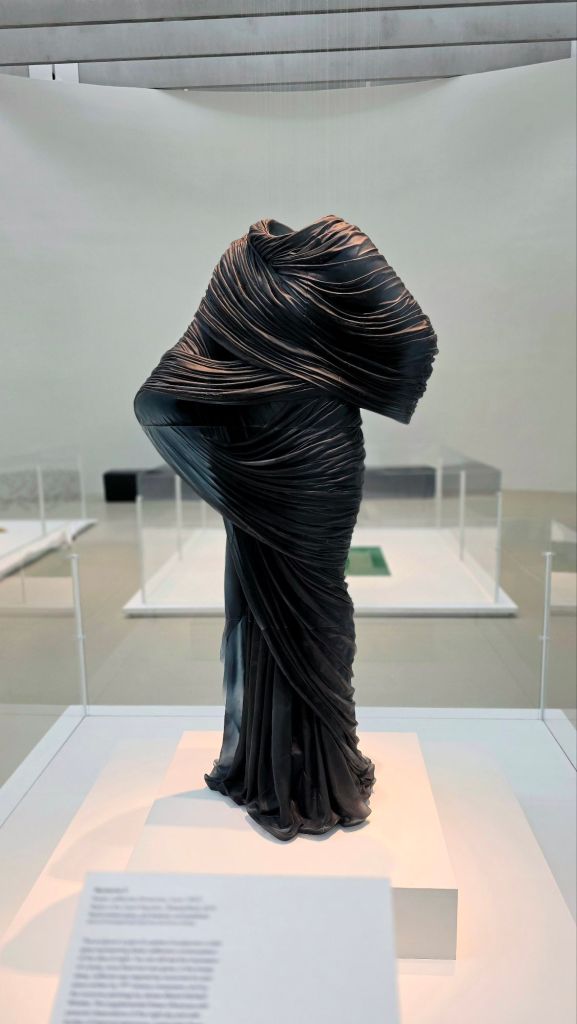 Glass sculpture of a robed woman figure