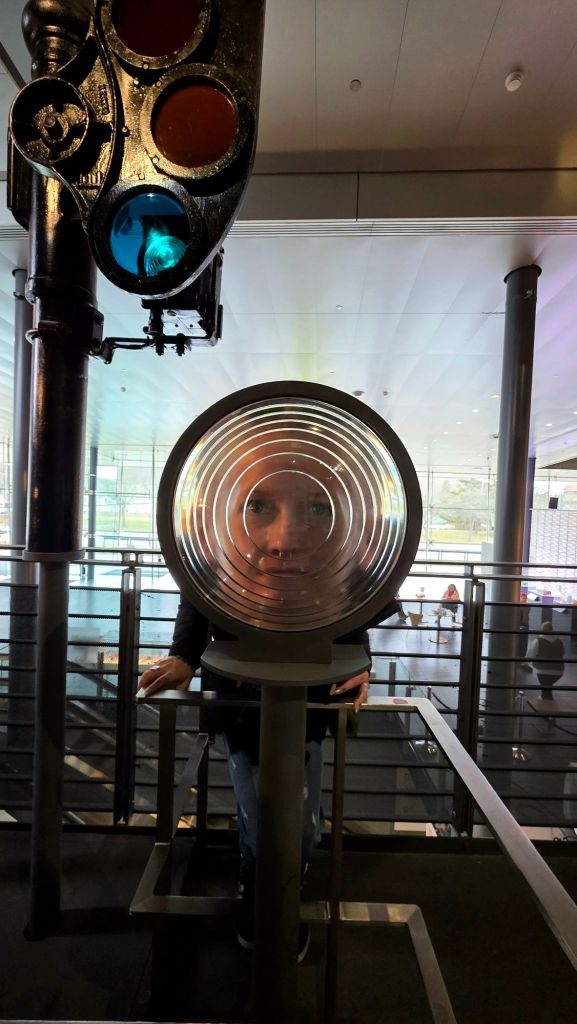 Kae Audhild playing with lenses at Corning Museum of Glass in Corning NY