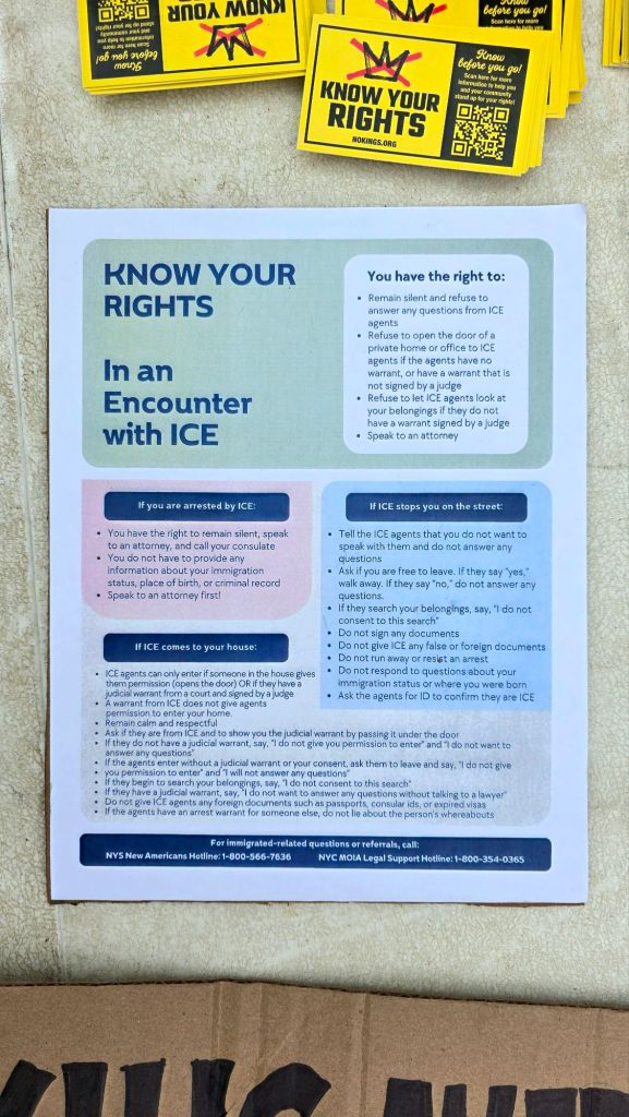 Know Your Rights flyers explaining how to respond during encounters with ICE, displayed at the ICE Out For Good protest in Ithaca, New York.