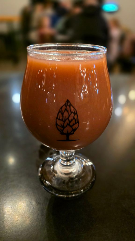 Trippy Trees Strawberry Vanilla beer served in a stemmed glass at Farm by Beer Tree Brew in Port Crane, New York
