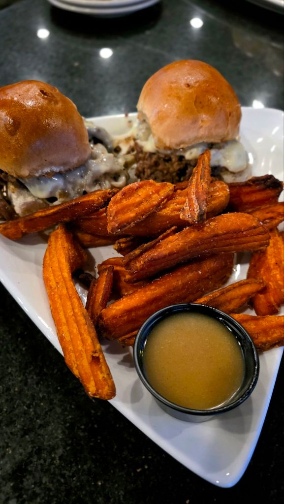 Prime rib sliders with melted provolone cheese and caramelized onions, served with crispy sweet potato fries and dipping sauce at The Preserve at 405 in Syracuse, NY.